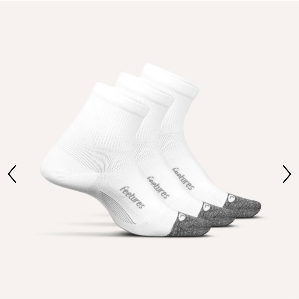 2 pairs of white Feetures Elite Quarter socks